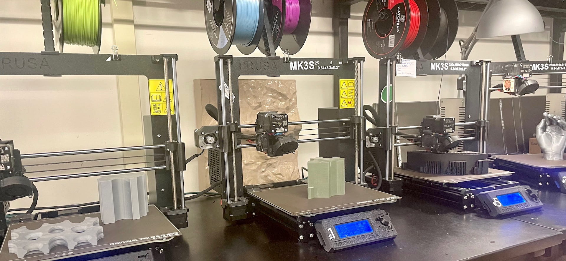 Photo of three 3D printers in digifab